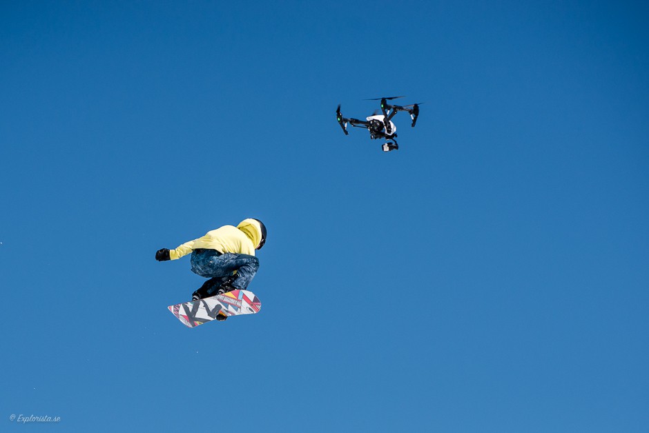 girl snowboard jump drone
